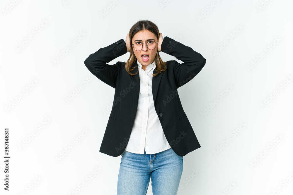 Young caucasian business woman covering ears with hands trying not to hear too loud sound. Young caucasian business woman covering ears with hands trying not to hear too loud sound.
