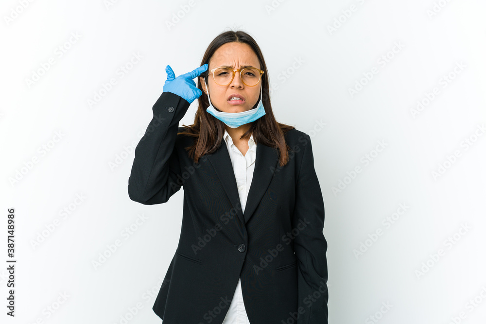 Young business latin woman wearing a mask to protect from covid isolated on white background showing a disappointment gesture with forefinger. Young business latin woman wearing a mask to protect from covid isolated on white background showing a disappointment gesture with forefinger.