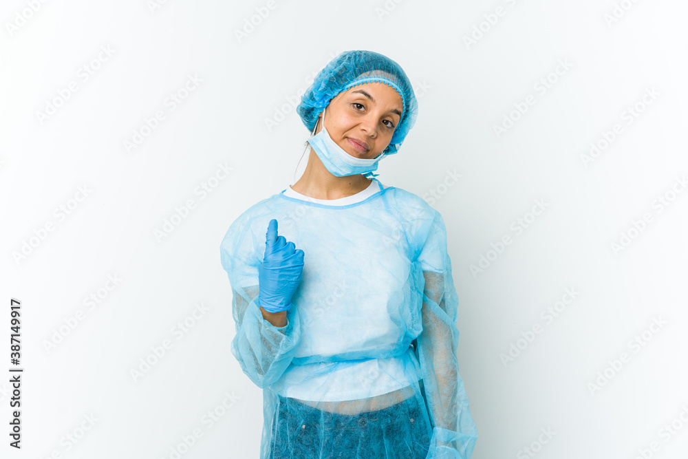 Young surgeon latin woman isolated on white background pointing with finger at you as if inviting come closer. Young surgeon latin woman isolated on white background pointing with finger at you as if inviting come closer.