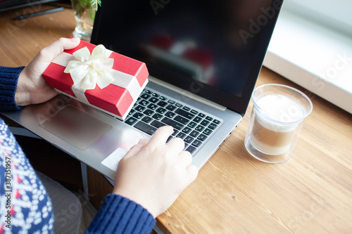Closeup on young woman making online shopping near christmas tree