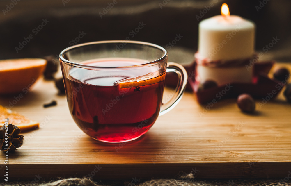 Red hot wine with spices, Christmas hot spicy drink. Seasonal mulled wine. Mulled wine with orange and cloves, selective focus. Red hot wine with spices, Christmas hot spicy drink. Seasonal mulled wine. Mulled wine with orange and cloves, selective focus.