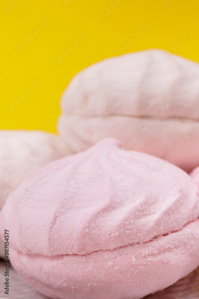 Tasty sweet zephyr on a plate and yellow background. Tasty sweet zephyr on a plate and yellow background.