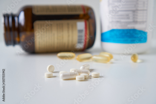 Tablets and dietary supplement cod liver oil with capsules and with panels drug spilling out of a bottle, healthcare and medicine medication cure.