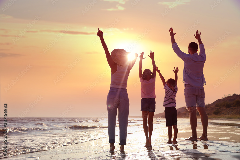 Fototapeta premium Family on sandy beach near sea. Summer vacation