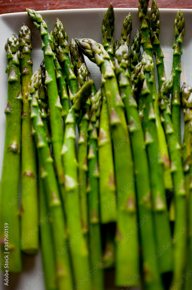 Fototapeta premium Asparagus. Sautéed organic vegetables in olive oil, herbs, spices and salt and pepper. Classic American steakhouse, restaurant or bistro side dish.