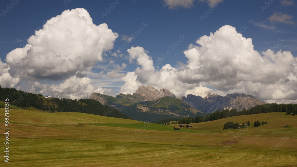 Landscape in the mountains. Alpe di Siusi: view on Odle group. Clouds on mountains panorama.
