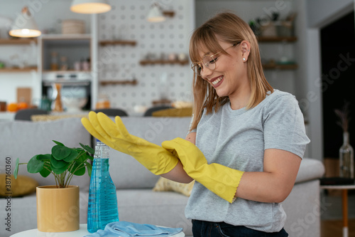 Young attractive woman cleaning home. Young beautiful woman at home