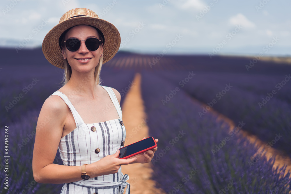 Young woman smartphone standing in field