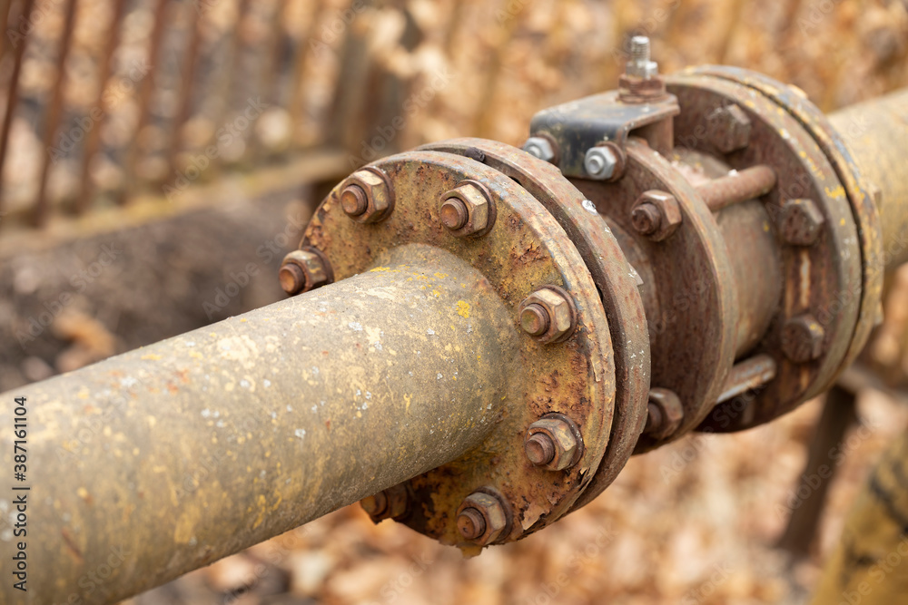 Fragments of old large gas pipe. Rusty brown curved metal iron pipe. Fragments of old large gas pipe. Rusty brown curved metal iron pipe.