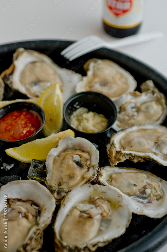 Oysters on the half shell. Fresh oysters served with garlic, shallots