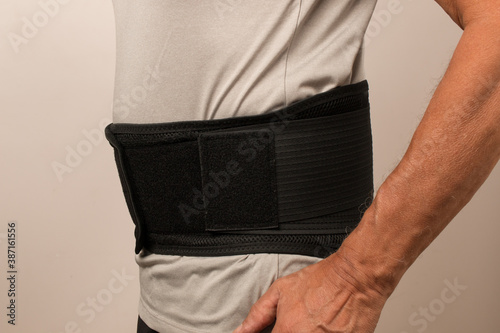 Man wearing a Back Brace for his injured back, Back Pain treatment
