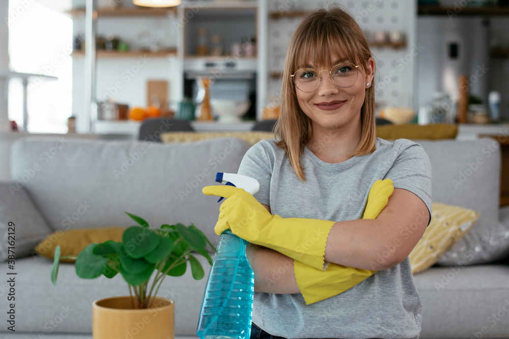 Young attractive woman cleaning home. Young beautiful woman at home