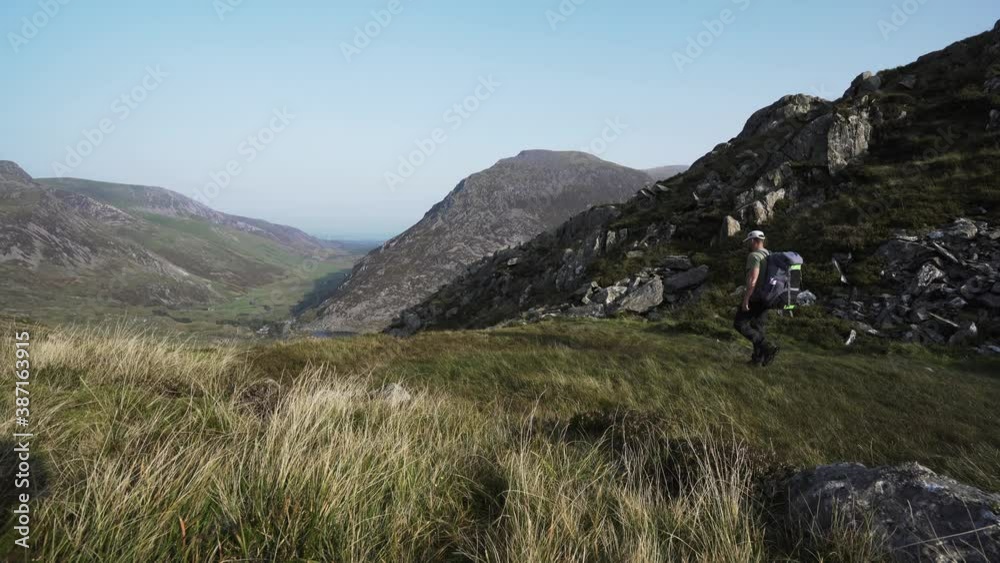 Snowdonia National Park walking trail with a man and rucksack Snowdonia National Park walking trail with a man and rucksack
