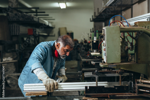 Aluminium and PVC industry worker making PVC frames for windows