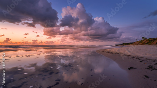 colorful sunset over the sea with beautiful clouds, reflection of clouds in the water