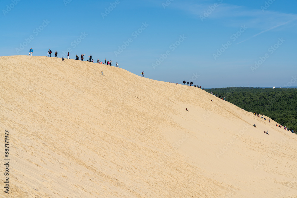 many tourists enjoy a visit to the ladnark Dune de Pilat in southwestern France many tourists enjoy a visit to the ladnark Dune de Pilat in southwestern France