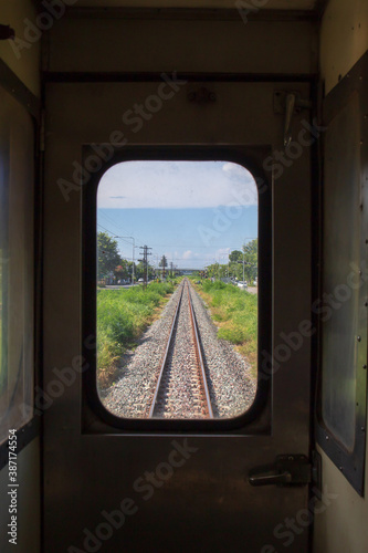 Railway crossing or junction road with railroad view from inside the train bogy. © Phongsak