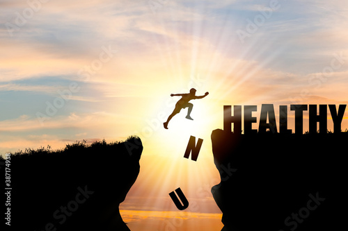 Human jumping over cliff mountain and healthy , Unhealthy wording.