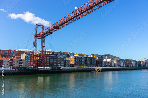 Portugalete, Spain - 10/17/2019: Biscay bridge flying with gondola over river Nervion. Portugalete landmark. Famous bridge called Puente de Vizcaya near Bilbao. Traffic and transfer concept. 