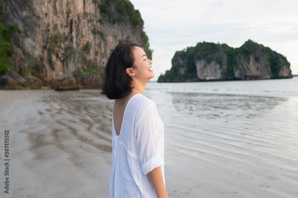 Young teenage woman girl with happy face smiling on the seashore beach coast holiday vacation for optimistic relaxation lifestyle Young teenage woman girl with happy face smiling on the seashore beach coast holiday vacation for optimistic relaxation lifestyle