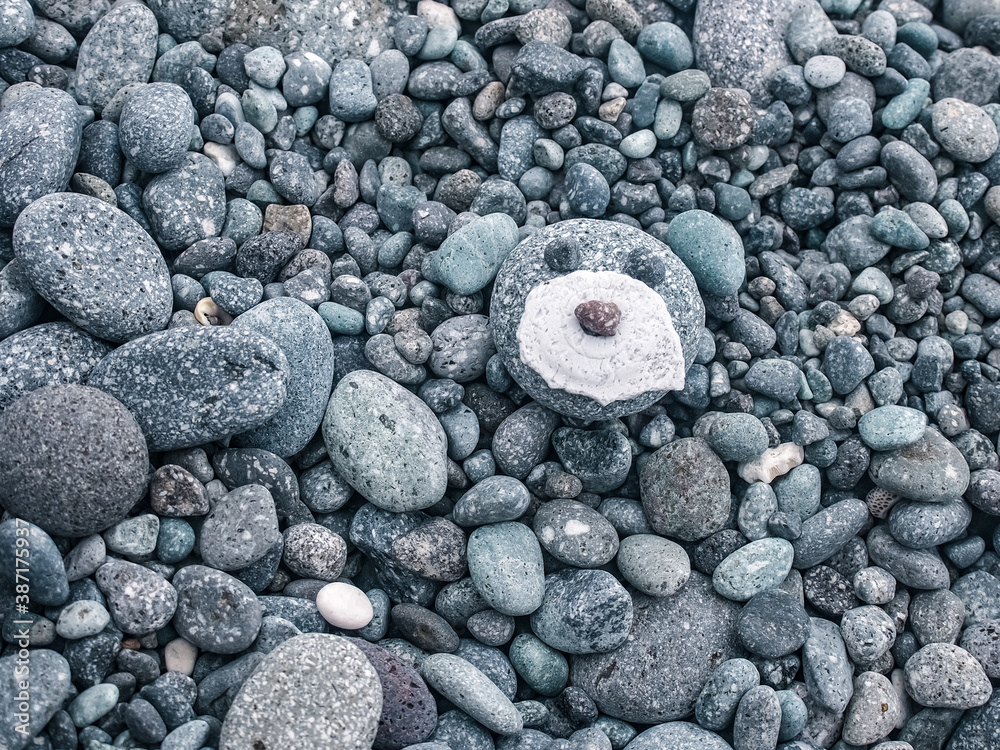 Pebbles stacked in the seaside. background. dog shape sotne.