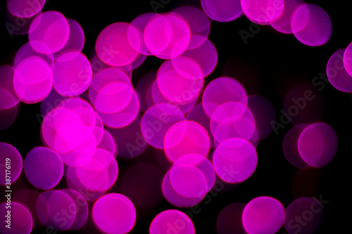 light purple beautiful party glitter light blur pattern in concert blur on black sky.