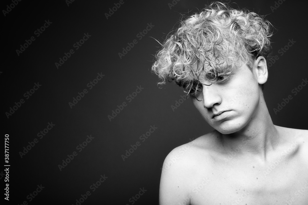 Skinny young man with curly hair shirtless in black and white Skinny young man with curly hair shirtless in black and white