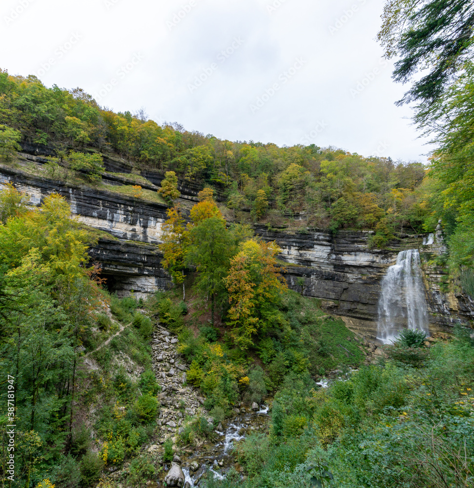 beautiful fall forest landscape with idyllic waterfall