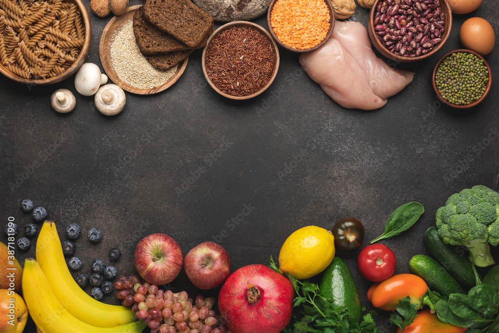 Whole grains and pasta, variety of vegetables, fruits and protein products on brown background. Balanced nutrition for healthy diet and immune system Whole grains and pasta, variety of vegetables, fruits and protein products on brown background. Balanced nutrition for healthy diet and immune system