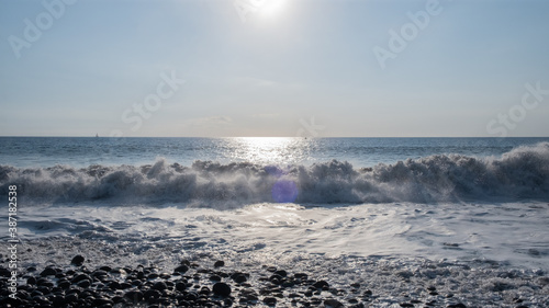 Sunset on a black stone beach