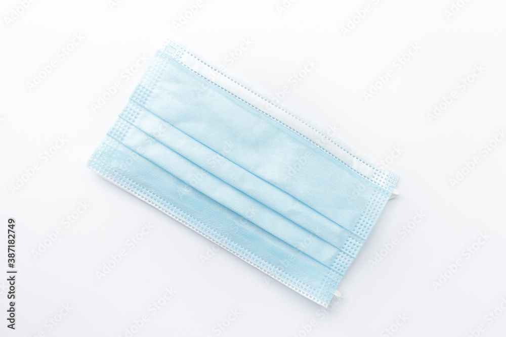 Fototapeta premium Surgical mask isolated on white background.Concept : Medical waste disposal during the novel COVID-19 pandemic.
