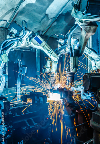 Robots welding in a car factory.
