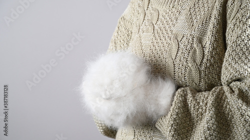 Girl holding gift wrapping in fluffy gloves