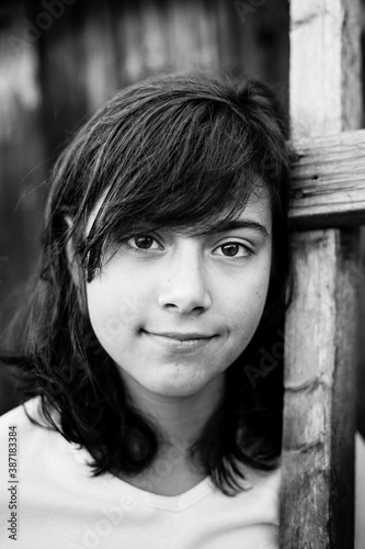 Portrait of the black-eyed teen girl, outdoor. Black and white photography.