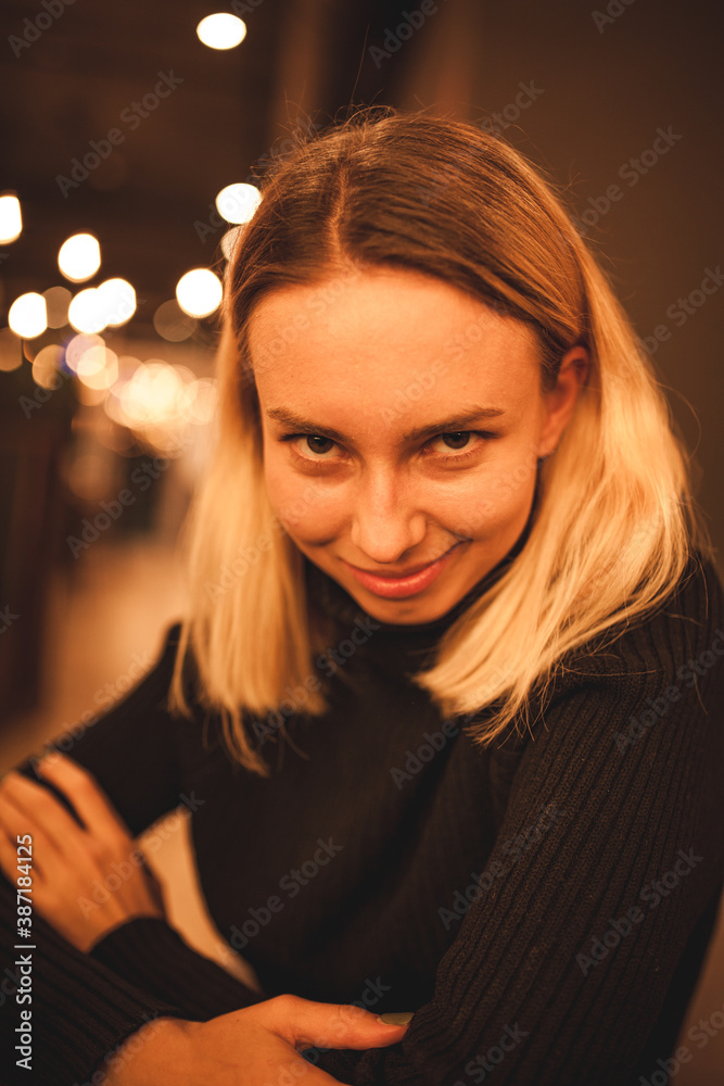Young woman sits in a cafe.Happy blonde is resting in a cafe. Portrait photo of a woman in a black sweater
Young woman sits in a cafe.Happy blonde is resting in a cafe. Portrait photo of a woman in a black sweater