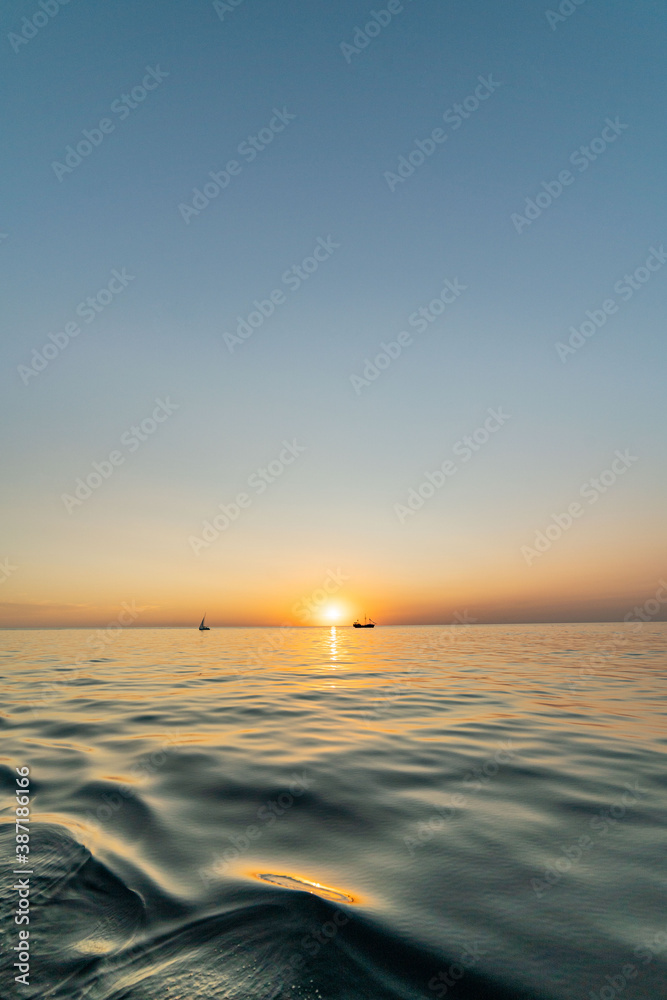 sunset at sea with boats