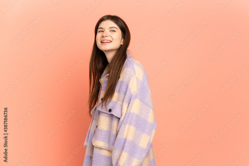 Young Ukrainian girl isolated on pink background looking to the side and smiling Young Ukrainian girl isolated on pink background looking to the side and smiling