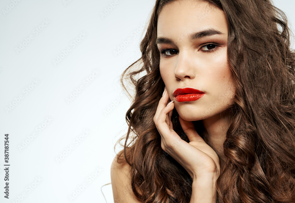 Model with bright makeup woman touches face with hand cropped view Model with bright makeup woman touches face with hand cropped view