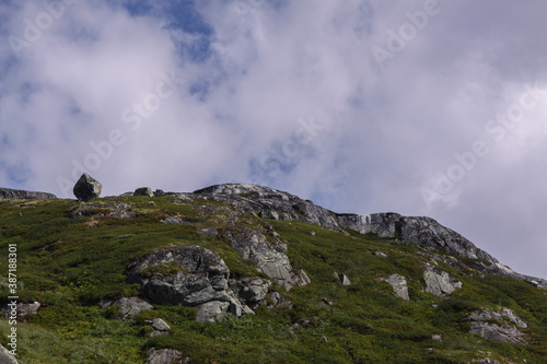 Norwegian landscape of a rocky slope against partially cloudy blue sky