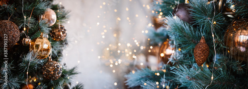 Banner with golden Christmas decoration and bokeh. Christmas background with copy space.