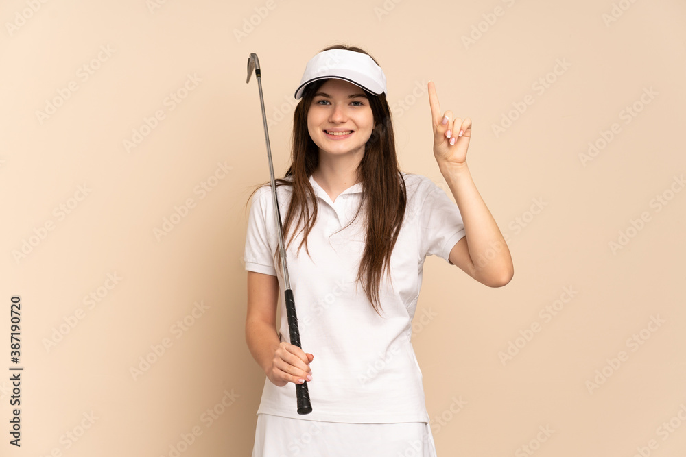 Young Ukrainian golfer girl isolated on beige background pointing up a great idea Young Ukrainian golfer girl isolated on beige background pointing up a great idea