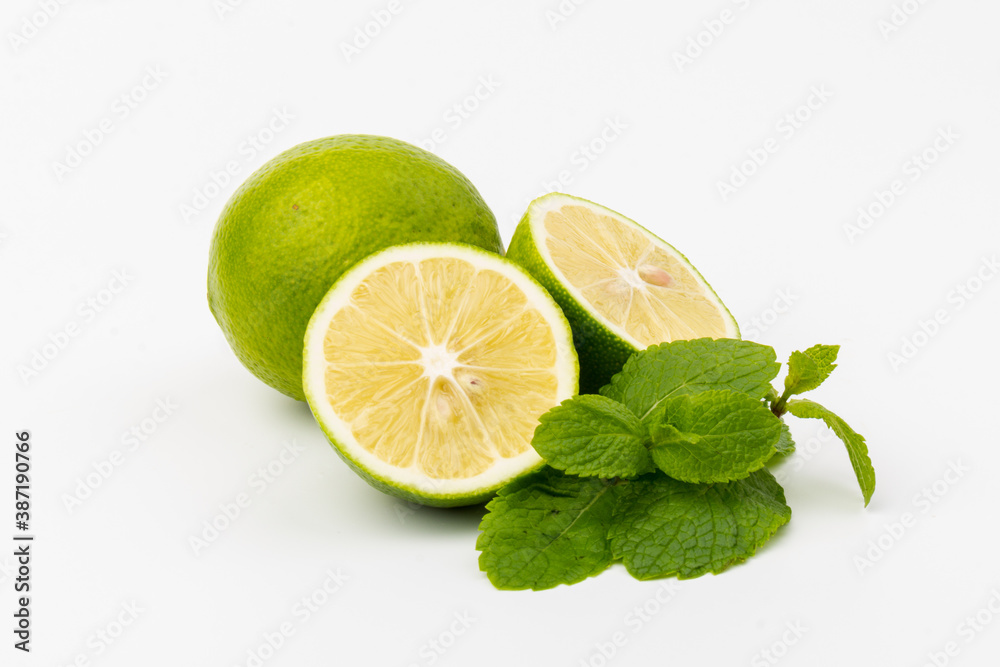 Lime with mint leaves isolated on white background. Lime with mint leaves isolated on white background.