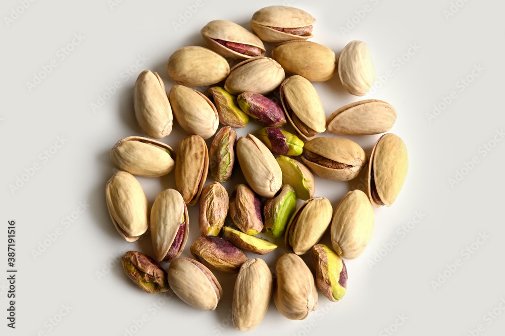Pistachios in walnut shell on white background, composition of pistachios excellent for a healthy and dietetic diet,antioxidant food