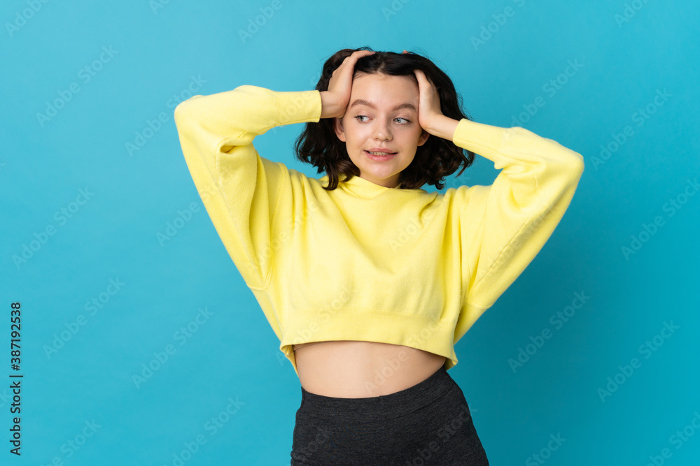 Teenager Ukrainian girl isolated on blue background doing nervous gesture Teenager Ukrainian girl isolated on blue background doing nervous gesture