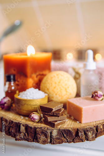 Comfort food concept. Small stack pieces of chocolate in bath room by hot tub. Cozy autumn self pampering time.