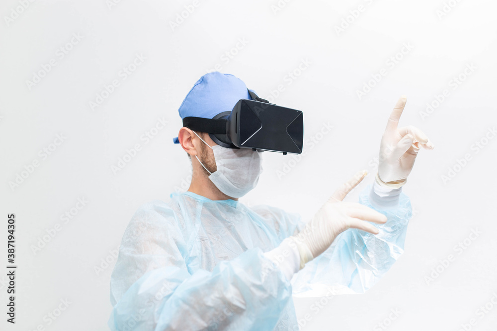 male doctor surgeon in uniform and VR glasses helmet, the use of virtual reality in medicine. Modern technologies in teaching. male doctor surgeon in uniform and VR glasses helmet, the use of virtual reality in medicine. Modern technologies in teaching.