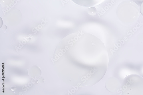 White glitter vintage lights background. White texture background. Oil drops in water.