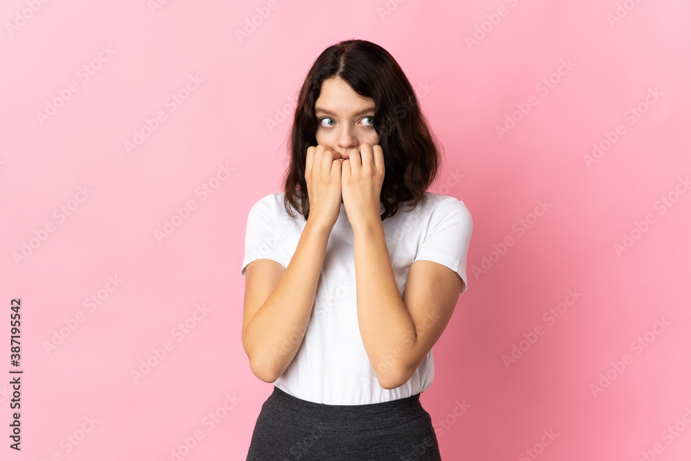 Teenager Ukrainian girl isolated on pink background nervous and scared putting hands to mouth Teenager Ukrainian girl isolated on pink background nervous and scared putting hands to mouth