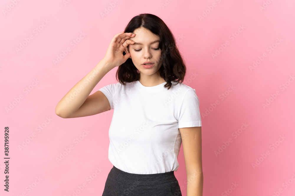 Teenager Ukrainian girl isolated on pink background with tired and sick expression