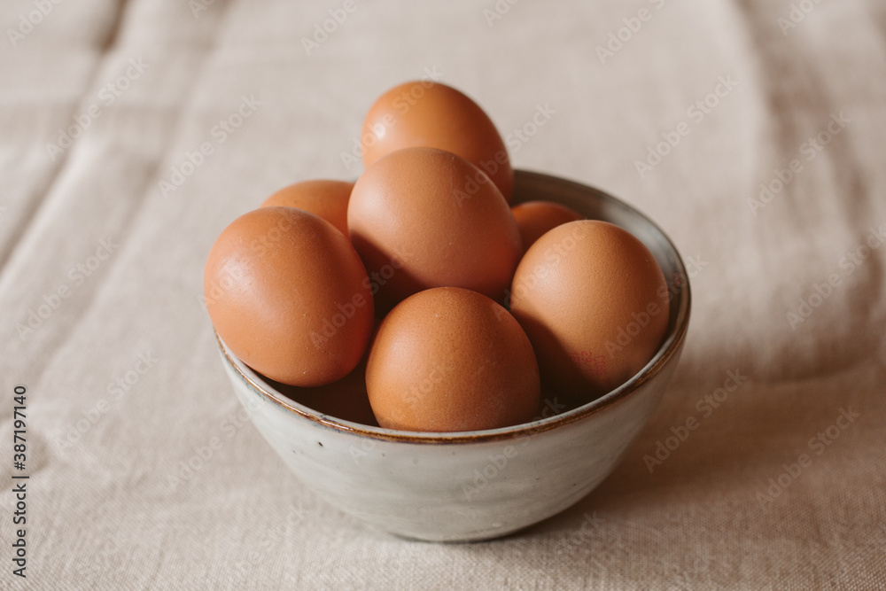 Eggs background. Closeup view of eggs in a bowl on rustic table as background. Organic and healthy food. Eggs background. Closeup view of eggs in a bowl on rustic table as background. Organic and healthy food.